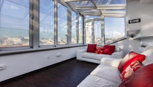 a living room with a white couch and large windows at Italianway Comfort - Torino 57 B in Milan
