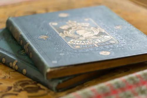 three books stacked on top of each other on a table at Piglet Lodge in Pebworth