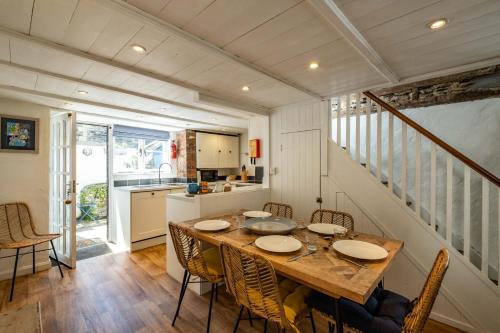 a kitchen and dining room with a table and chairs at Sea Horses in Port Isaac
