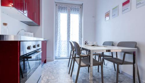a kitchen with a table and chairs in a kitchen at Italianway Comfort - Merlo 1 D in Milan