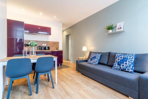 a living room with a couch and a table and chairs at Lille Centre - Nice ap. 4pers in Lille