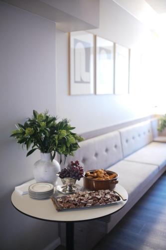 a table with plates and bowls of food on it at Hotel Local 101 in Reykjavík