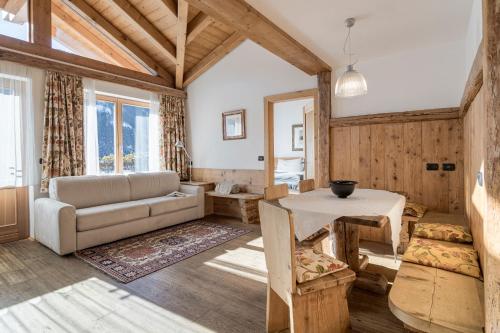 a living room with a couch and a table at Cësa Marmolada 1318 in Ortisei
