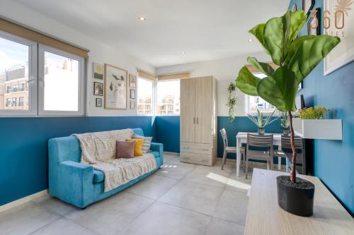 a blue living room with a couch and a table at Modern Paceville Suites with WIFI & AC by 360 Estates in Paceville