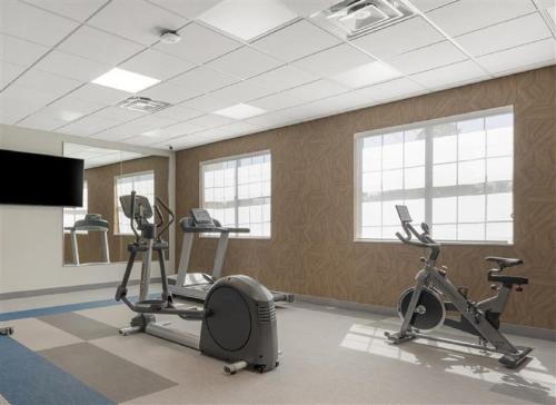 a gym with two exercise bikes and a flat screen tv at Pestana Orlando Suites - Lake Buena Vista in Orlando