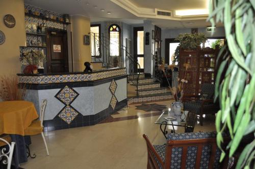 a restaurant with a lobby with a table and chairs at Al-Tair in San Vito lo Capo