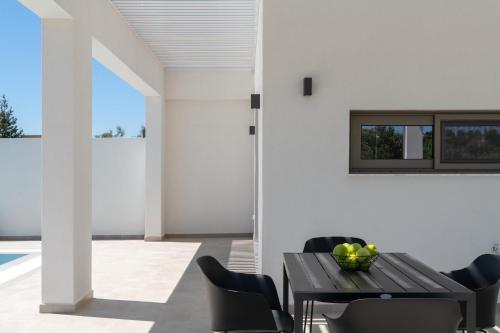 a dining room with a table and chairs at Armonia Suites in Gennadi
