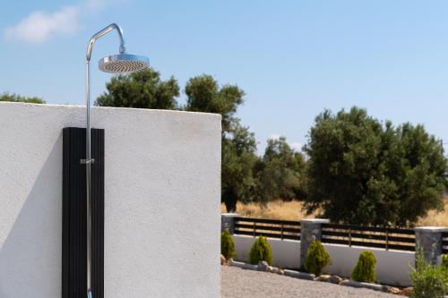 a street light on the side of a wall at Armonia Suites in Gennadi
