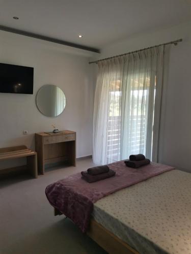 a bedroom with a bed and a large window at CASA QUERCU in Sykia Chalkidikis