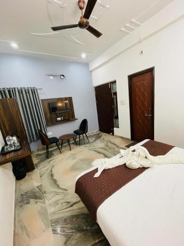 a hotel room with a bed and a ceiling fan at Hotel Sangam View in Prayagraj