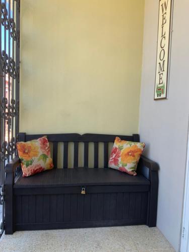 a black couch with two pillows sitting in a room at Boricua Guest House Apartment in Yauco