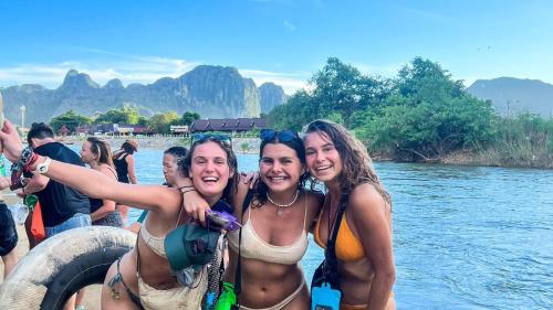 a group of women in the water on a boat at Mad Monkey Vang Vieng in Vang Vieng