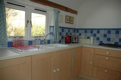 a kitchen with a sink and a window at The Granary at Palm Tree House in S.E. Kent in Lyminge