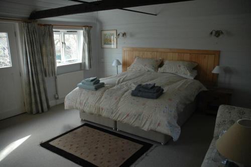a bedroom with a bed with two towels on it at The Granary at Palm Tree House in S.E. Kent in Lyminge