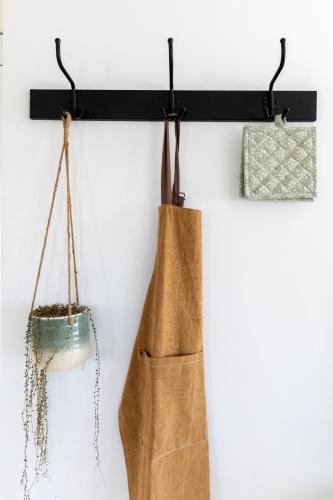 a black shelf with two bags hanging on a wall at The Oceanfront Private Northern Lights Villa in Reynivellir