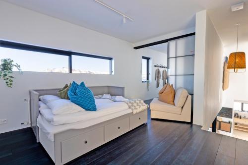 a bedroom with a large bed and a couch at The Oceanfront Private Northern Lights Villa in Reynivellir