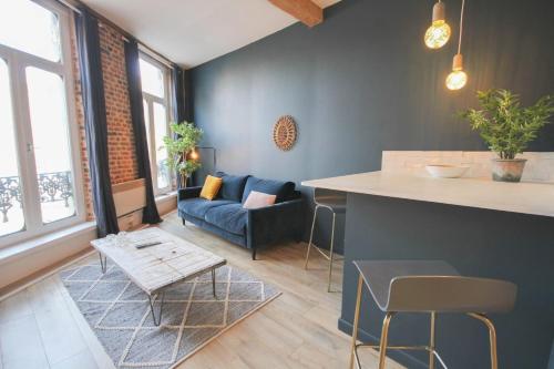 a living room with a couch and a table at Old Town apartment with view in Lille