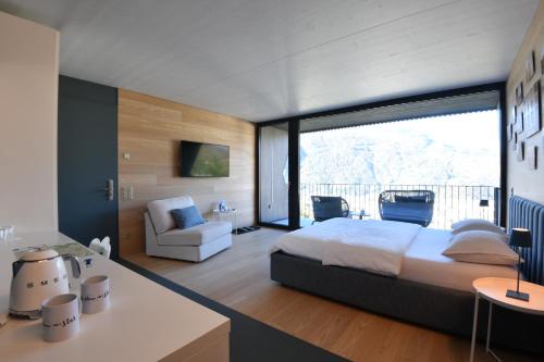 a bedroom with a king sized bed and a balcony at The Window in Bellinzona