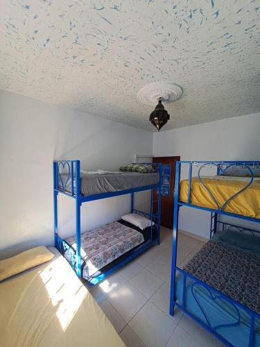 two bunk beds in a room with a ceiling at Moroccan Family House in Agadir