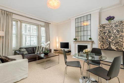 a living room with a couch and a table at Spacious, Calm One Bedroom in London