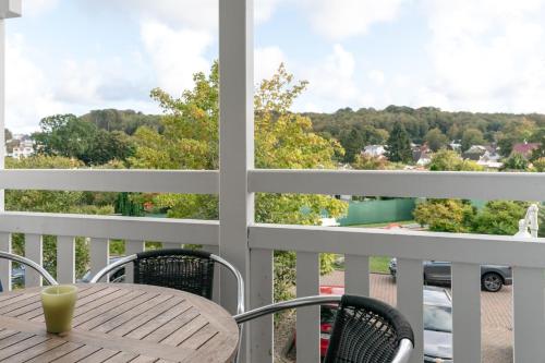 una mesa y sillas en un balcón con vistas en Fewo 300, Seepark Sellin, en Ostseebad Sellin