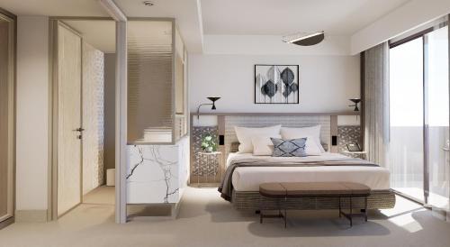 a bedroom with a large bed and a large window at Creta Star Hotel - Adults Only in Skaleta
