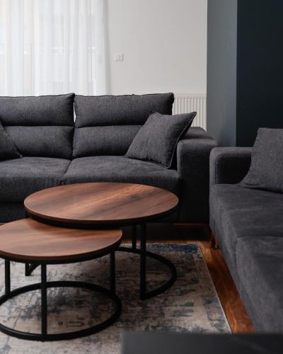 a living room with a couch and a table at Emery Apartments in Pristina
