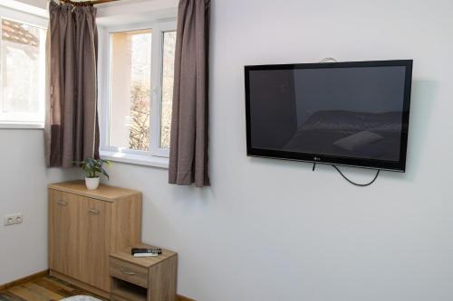 a flat screen tv hanging on a wall at Navial in Gabrovo