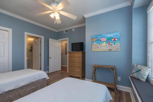 a bedroom with two beds and a ceiling fan at Retreat 5B - Edisto Blessing in Edisto Island