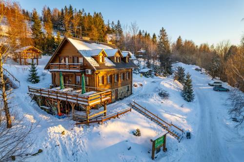 an aerial view of a house in the snow at Domki - Zajazd Zieleńska Polana in Wisła