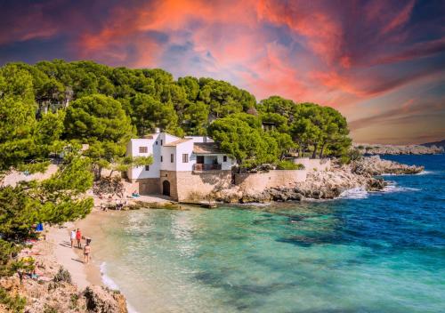 a group of people on a beach near the ocean at Onmood Cala Ratjada - Bed & Brunch in Cala Ratjada