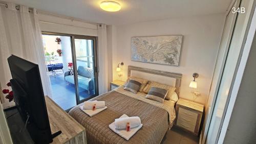 a bedroom with a bed with two candles on it at TIMORA SEA VIEW New Apart' Hipocampos in Calpe