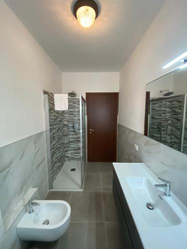 a bathroom with a sink and a toilet and a shower at COZY LAKE COMO APARTMENTS in Valmadrera