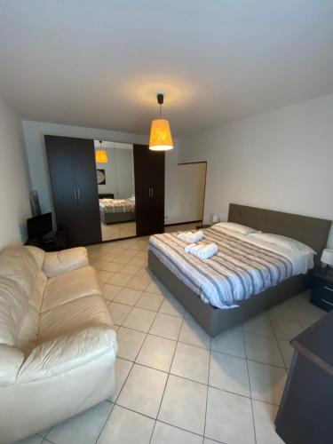 a large bedroom with a bed and a couch at COZY LAKE COMO APARTMENTS in Valmadrera