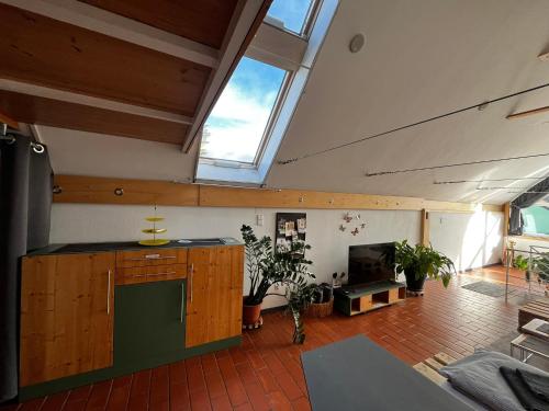 a large room with a kitchen and a fireplace at Bonito - Historischer Streckhof in Schützen am Gebirge
