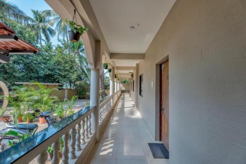an empty balcony of a house with plants at Rosa Bella Resort-TBV in Calangute