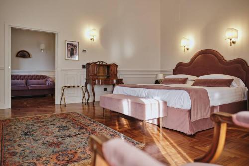a bedroom with a large bed and a couch at Villa Lena Puglia in Oria