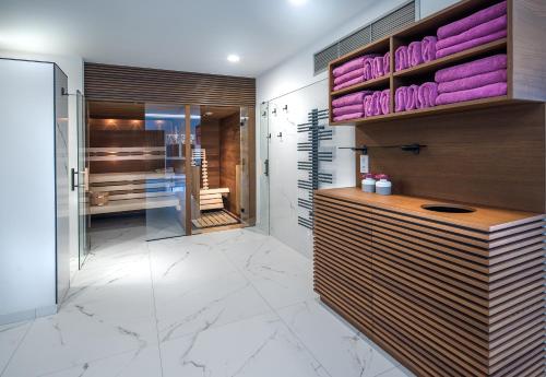 a bathroom with purple towels on a wall at Rosenhof Salzburger Seenland in Strasswalchen