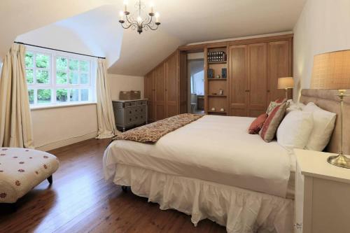 a bedroom with a large bed and a window at Rare Opportunity to stay on Unique Private Estate in Malahide