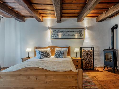 a bedroom with a wooden bed and a wood stove at Mesendorf Gasthaus in Meşendorf