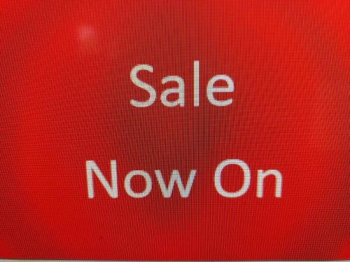 a red stop sign that says sale now on at The Townhouse Accommodation in Dumfries