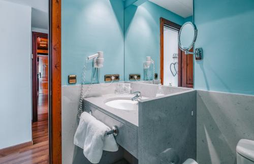 a bathroom with a sink and a mirror at Hotel Calitxo in Molló