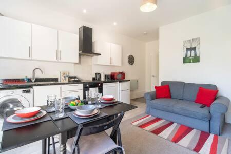 cocina y sala de estar con mesa y sofá azul en Ruby Suite Moseley Mews by StayStaycations en Birmingham