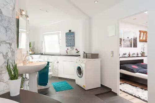 a bathroom with a sink and a washing machine at Top City Apartment Uniklinik in Freiburg im Breisgau