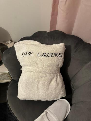 a throw pillow on a couch with the words gift cushion at Gîte & Spa CASANOU in Colmar