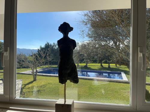 a statue of a woman standing in front of a window at Villa das Oliveiras in Sintra