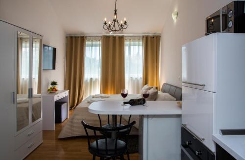 a kitchen and living room with a white refrigerator and a table at Apartment Victoria II in Dubrovnik