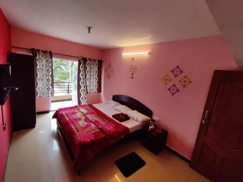 a bedroom with a bed in a pink room at Ooty Silver Wood Residency in Ooty
