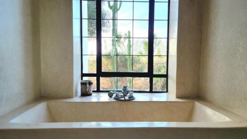 d'une baignoire devant une fenêtre avec un lavabo. dans l'établissement Villa Dar Céleste, à Essaouira