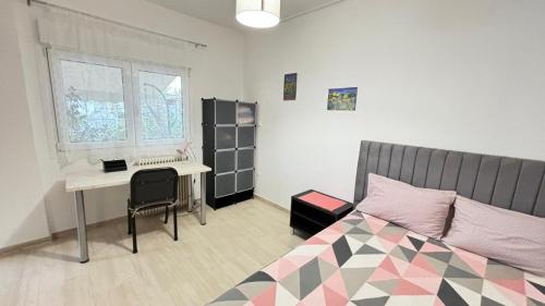 a bedroom with a bed and a desk and a desk at Cozy home in Kypseli in Athens